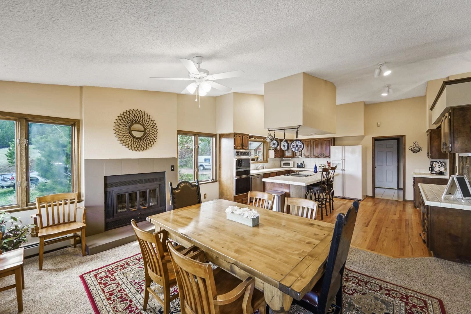 Open-concept kitchen and dining with mountain window view