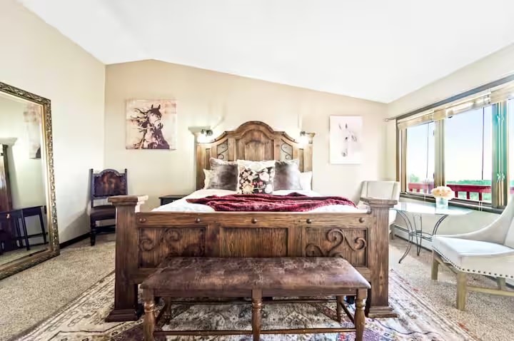 Master bedroom with ornate king bed and horse artwork
