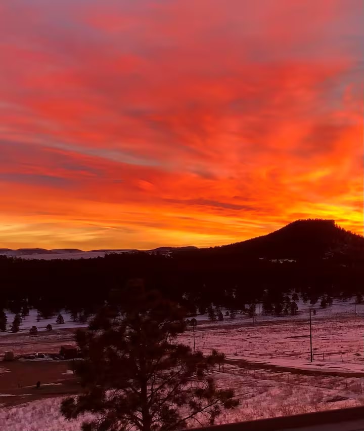 Dramatic fiery winter sunrise over snowy Colorado mountains