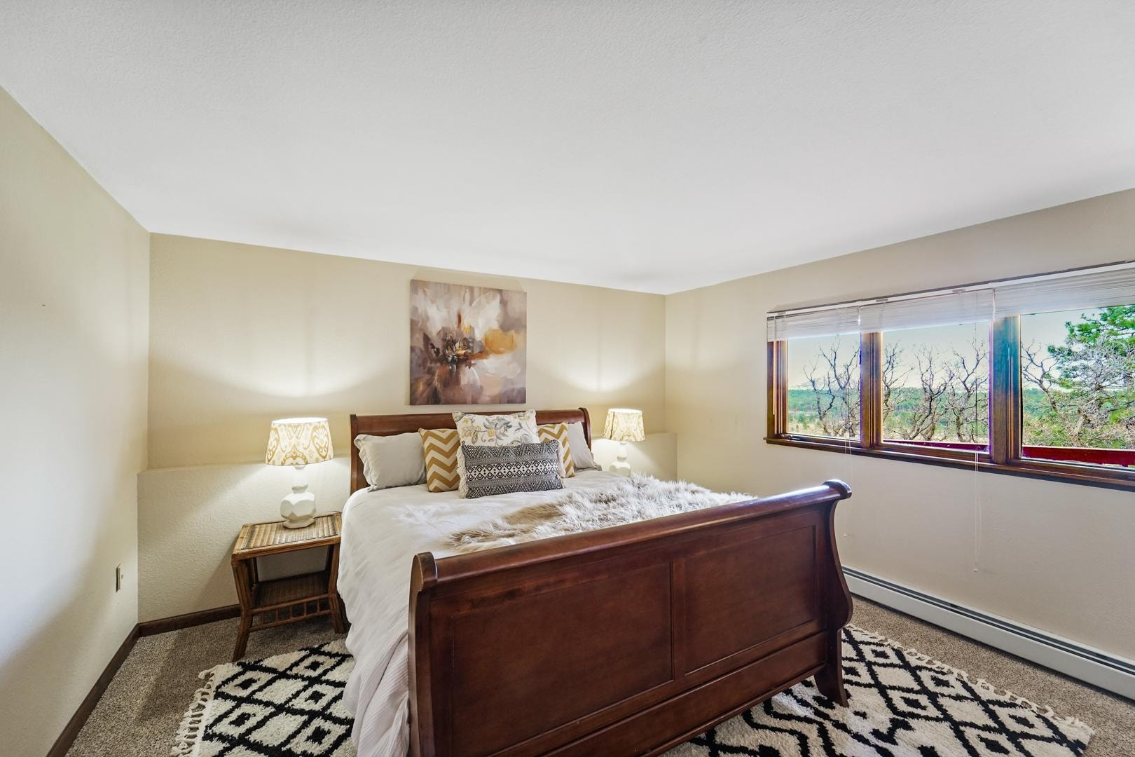 2nd master bedroom with king bed and tree views