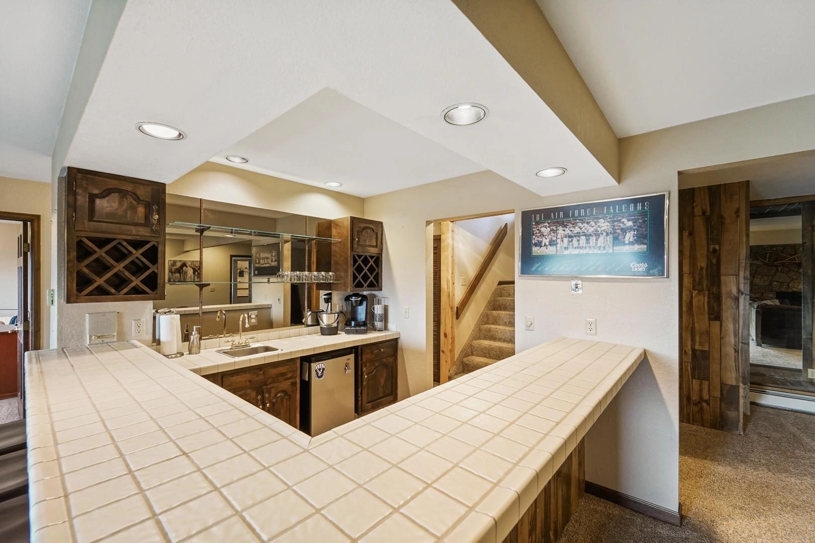 Downstairs bar with wine rack and tile countertop