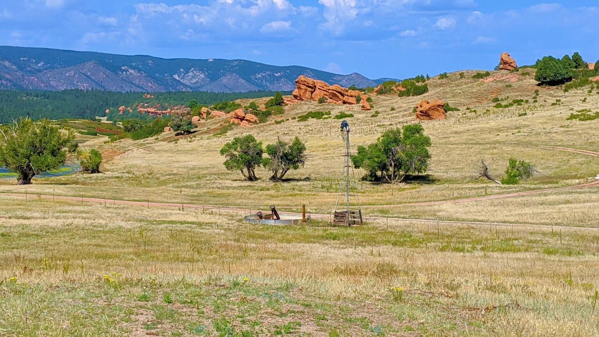 Sandstone Ranch open space with red rock formations and windmill